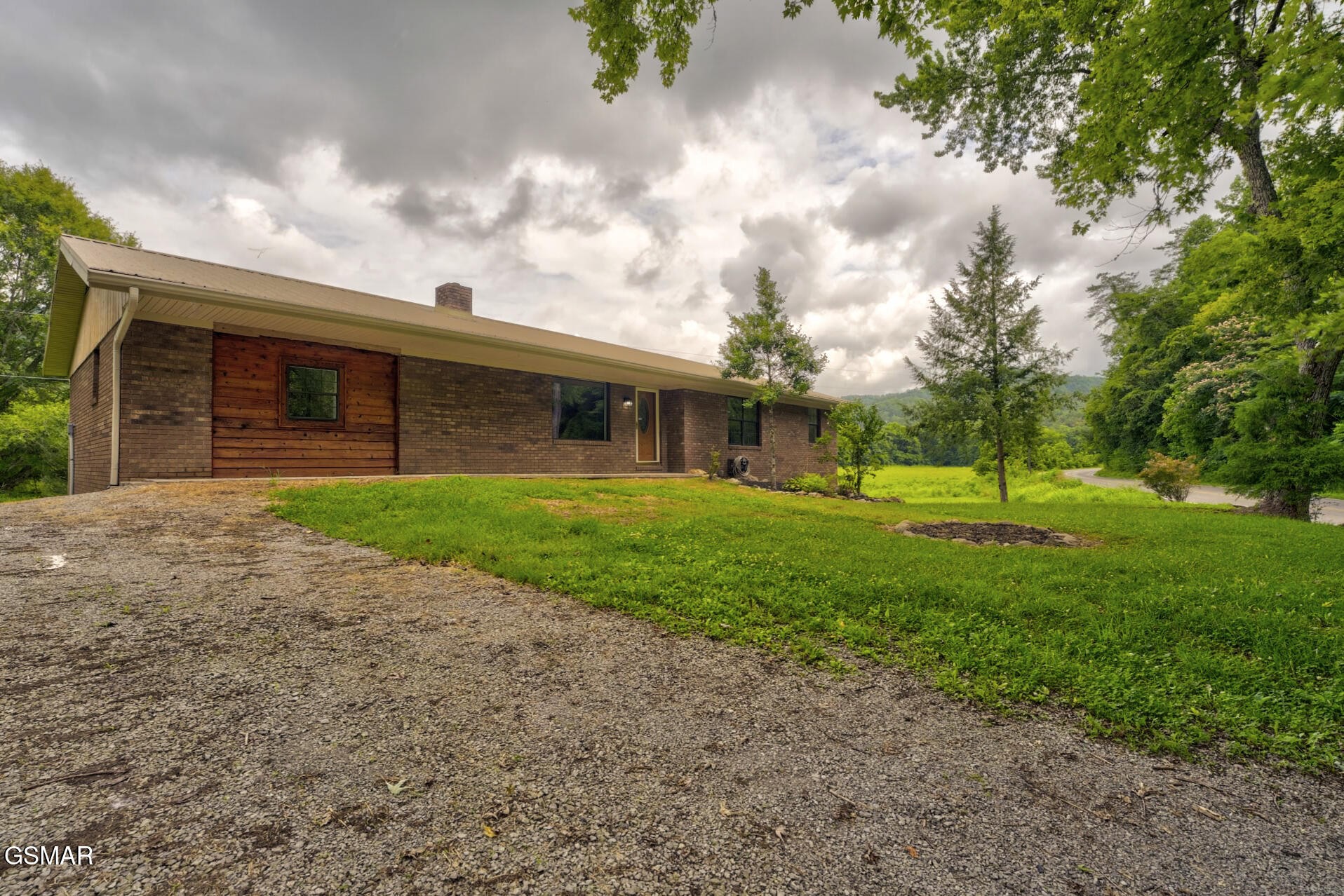 4405 Pearl Valley Road Sevierville, TN 37876 - Photo 1 of 39 a view of a house with a big yard and large trees