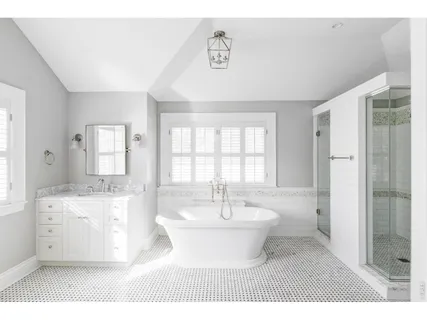 a spacious bathroom with a double vanity sink a mirror and a bathtub