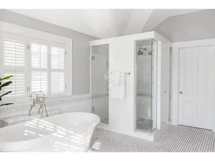 a bathroom with a tub sink and shower