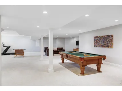 a room with furniture pool table and table