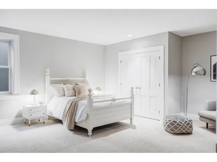 a bedroom with a bed and a couch