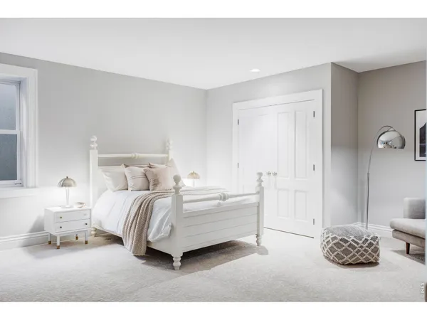 a bedroom with a bed and a couch