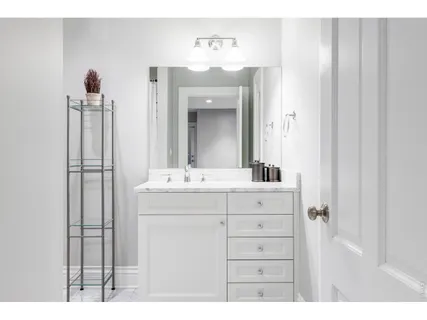 a bathroom with a sink vanity and a mirror
