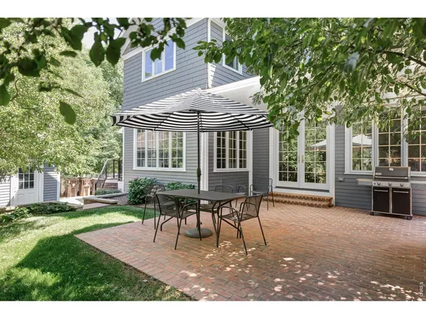 a patio with table and chairs