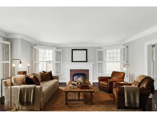 a living room with furniture a fireplace and a window
