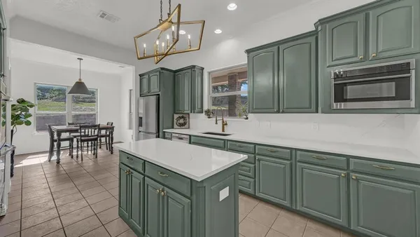 a kitchen with a sink cabinets and microwave