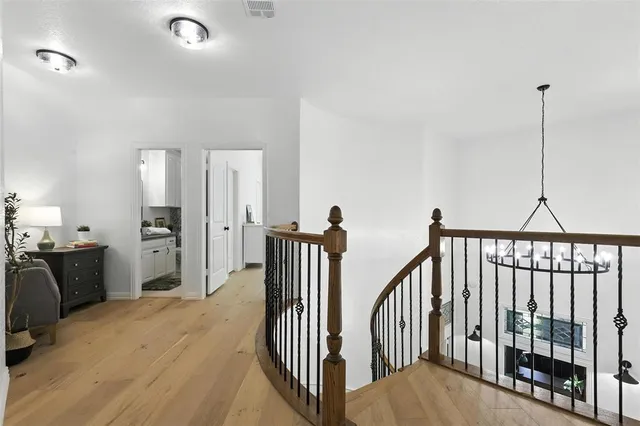 a view of a hallway with a flat screen tv