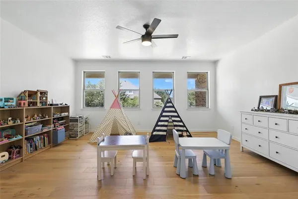 a living room with furniture a rug and a book shelf