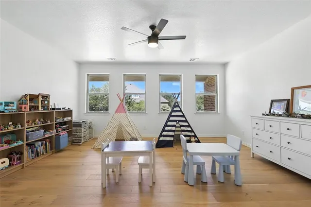 a living room with furniture a rug and a book shelf