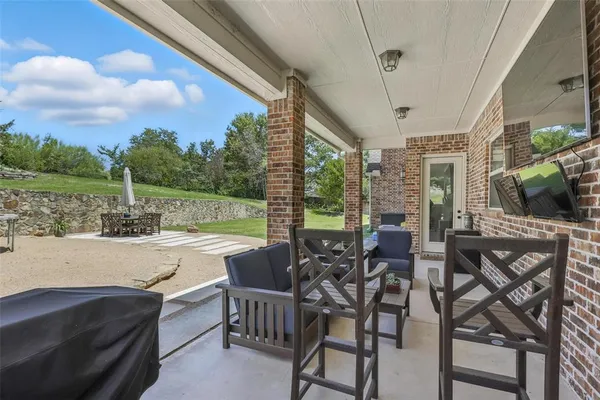 a view of a patio with couches table and chairs and potted plants