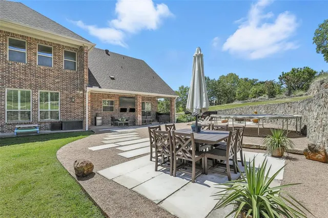 a view of a patio with couches and table and chairs and potted plants