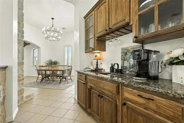 a kitchen with stainless steel appliances granite countertop a sink a stove and cabinets