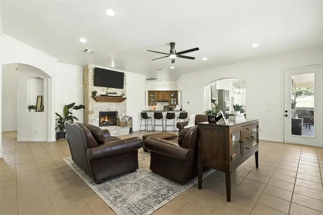 a living room with furniture a flat screen tv and a fireplace