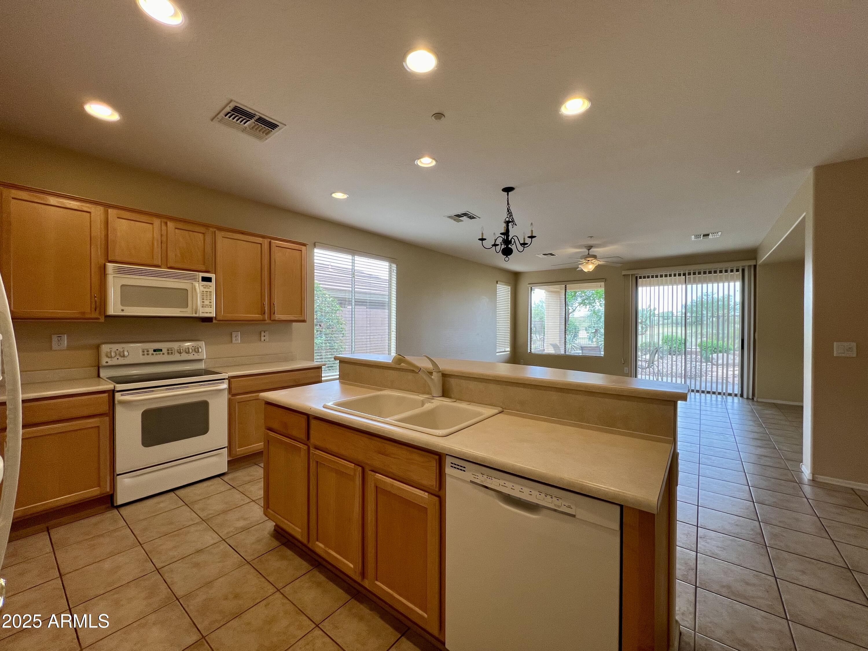 41018 North Prestancia Way Anthem, AZ 85086 - Photo 12 of 29 a kitchen with a stove sink and cabinets