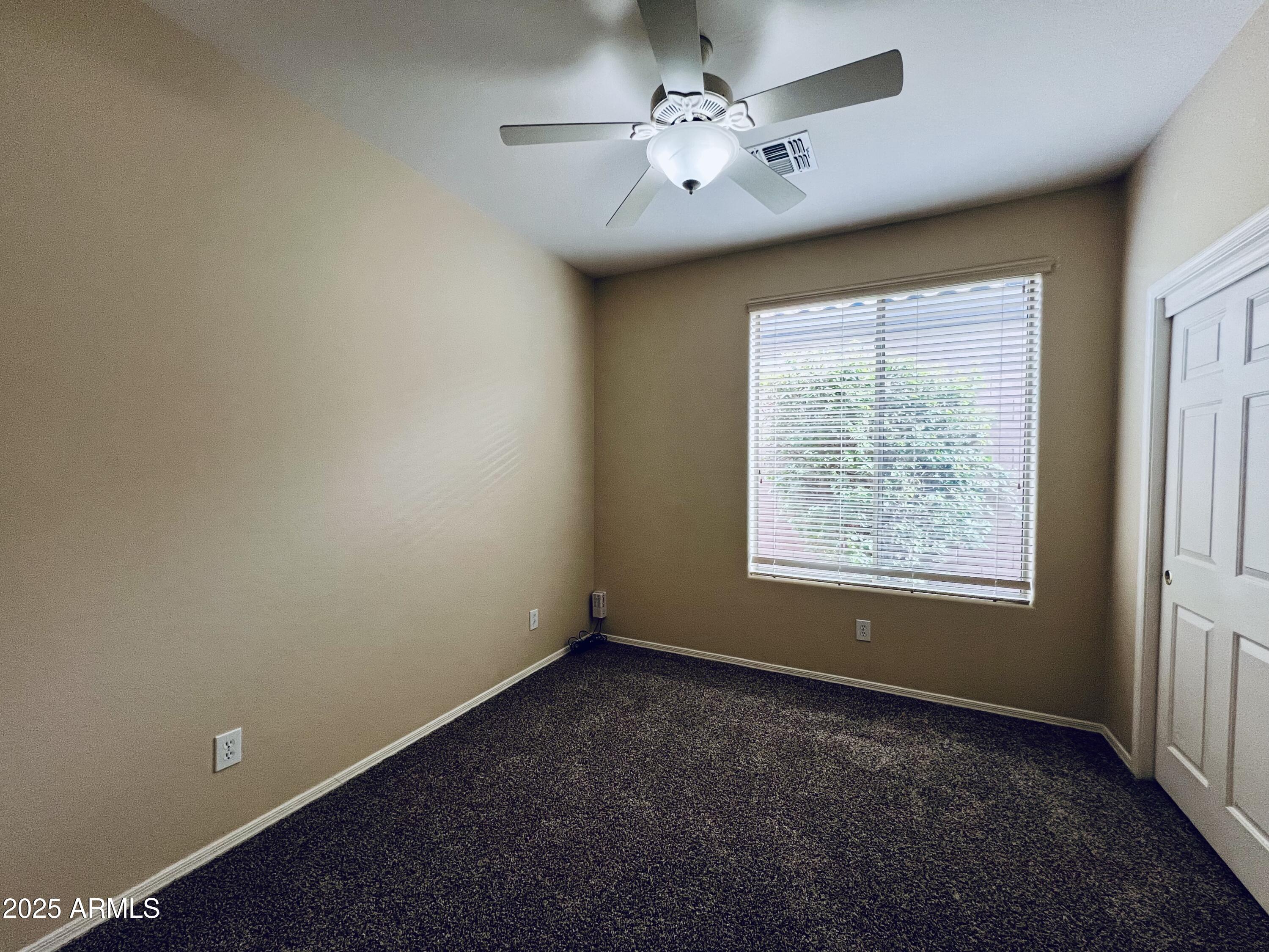 41018 North Prestancia Way Anthem, AZ 85086 - Photo 16 of 29 an empty room with a window and a fan