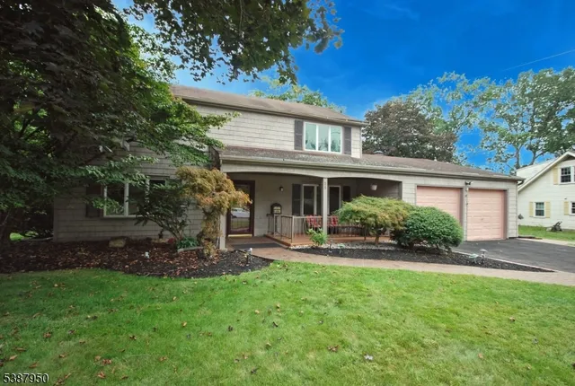 a view of a house with a yard and sitting area