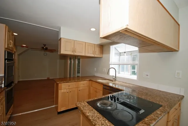 a kitchen with a sink a stove and a window