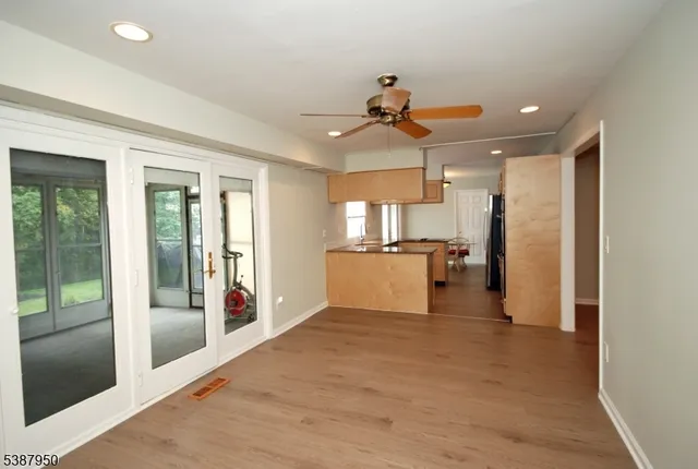 a view of a kitchen with a sink and refrigerator
