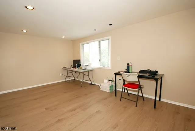 a view of a livingroom with wooden floor and a window