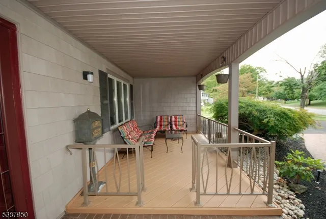 a backyard of a house with plants and large trees