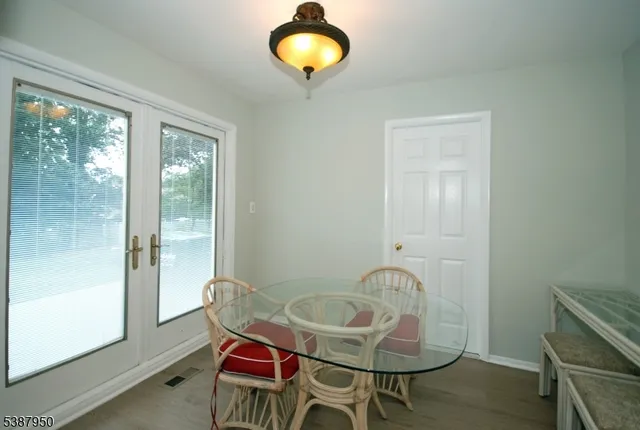 a dining room with furniture and a window