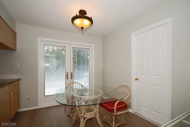 a dining room with furniture and wooden floor