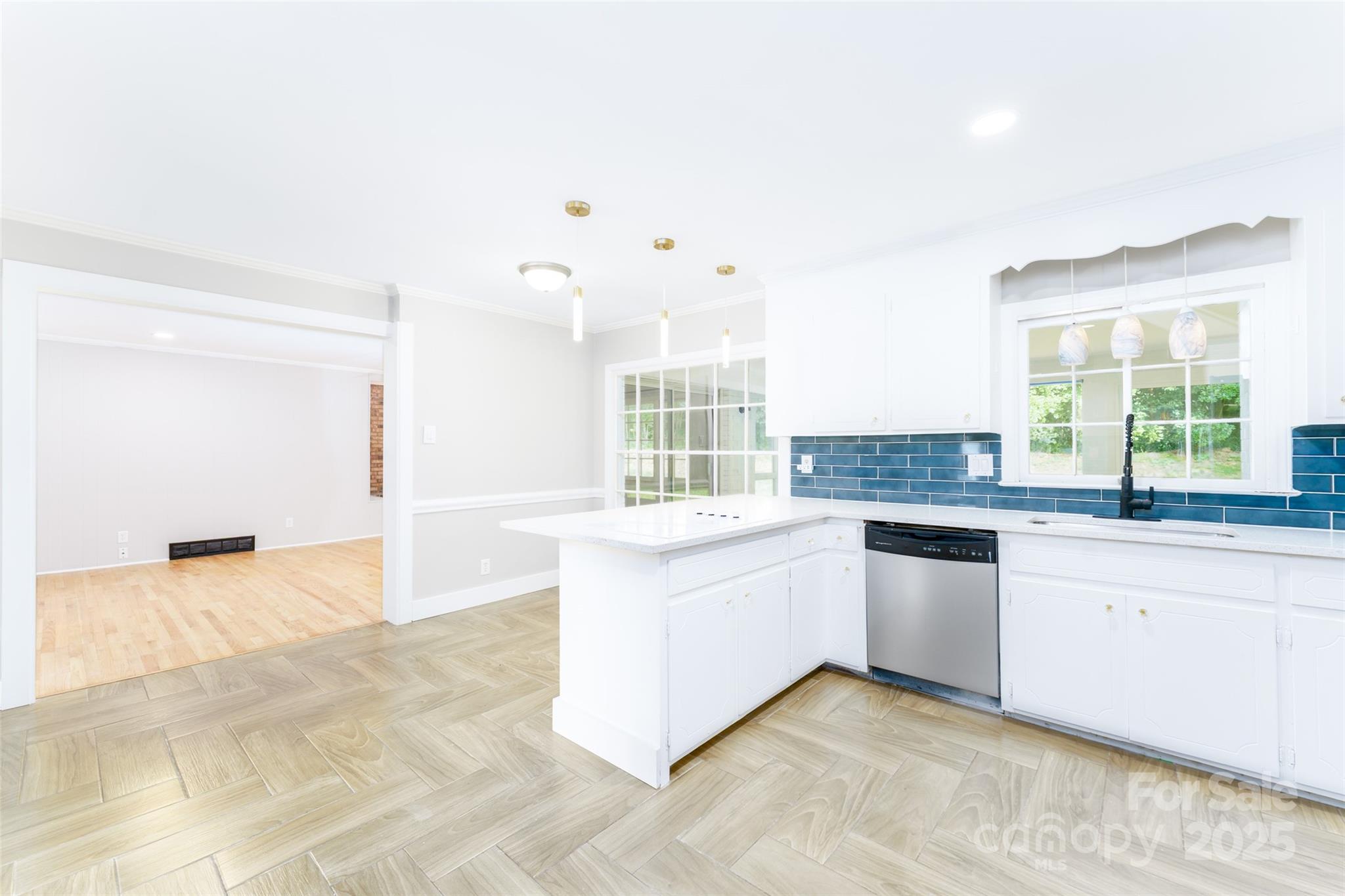 1728 Colony Road Salisbury, NC 28144 - Photo 10 of 20 a large white kitchen with a sink and dishwasher a stove top oven with wooden floor