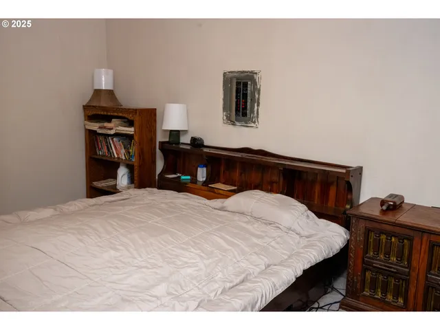 a bedroom with a bed and a dresser