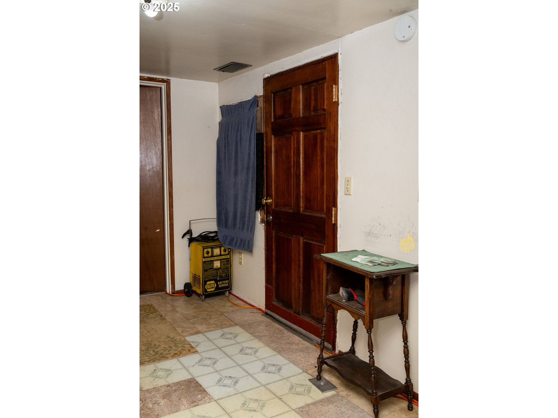 6981 Main Street Springfield, OR 97478 - Photo 8 of 8 a view of hallway with a chair and frames on wall