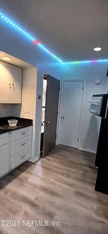 a view of an entryway with wooden floor