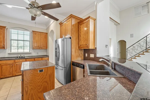 a kitchen with stainless steel appliances granite countertop a sink stove and refrigerator