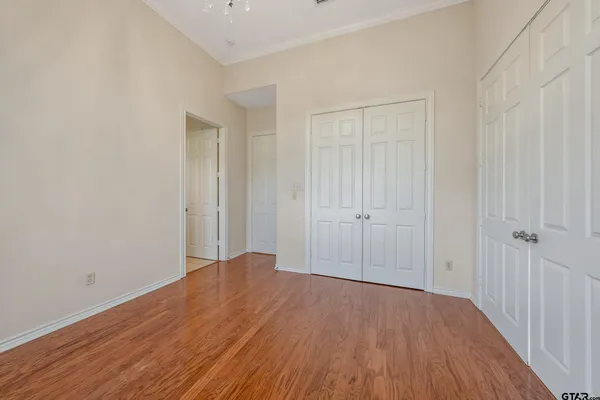 a view of an empty room with wooden floor