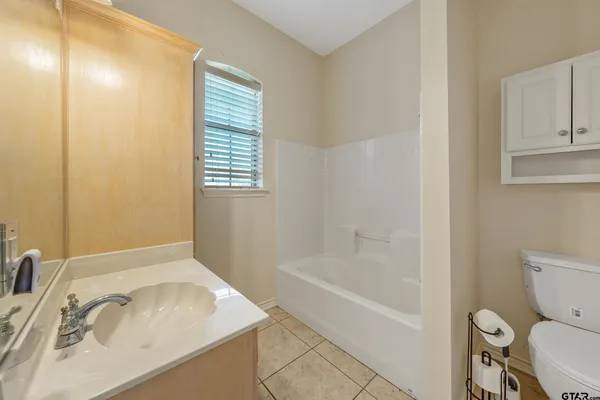 a white bath tub sitting next to a toilet