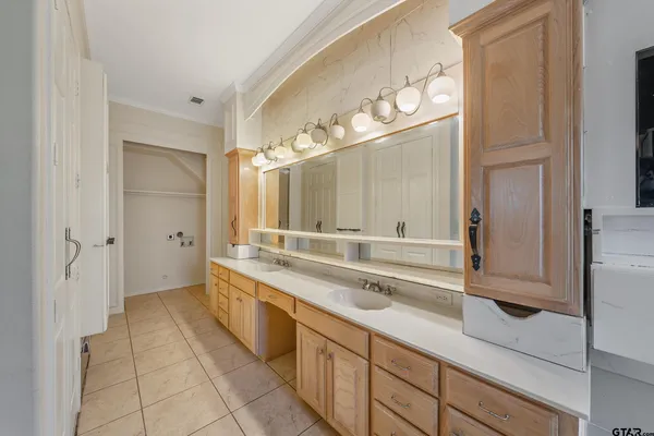 a large bathroom with a double vanity sink and a mirror