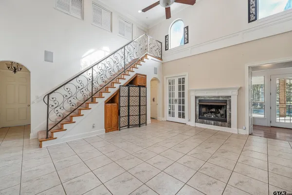 a view of entryway and hall with a fireplace