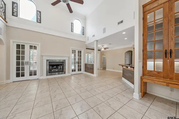 an empty room with fireplace and windows