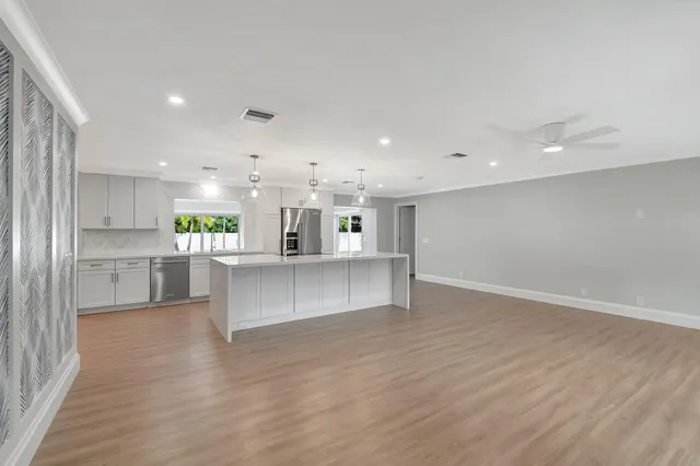 a view of kitchen with kitchen island and stainless steel appliances