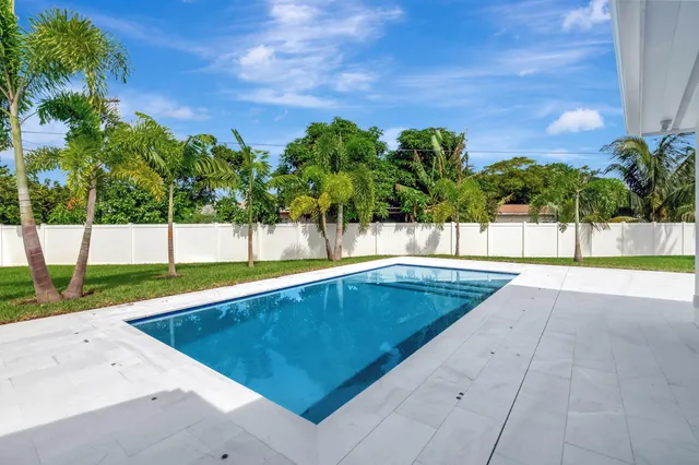 a view of a swimming pool with a yard