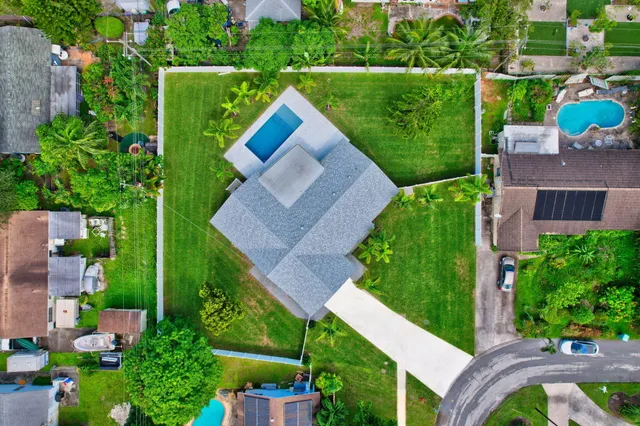 an aerial view of a house with garden space and street view