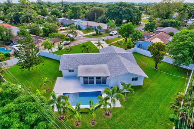 an aerial view of a house with yard swimming pool and outdoor seating