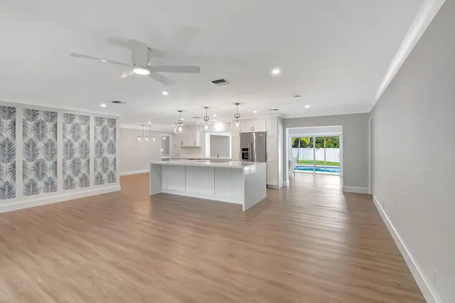 a view of kitchen and hall with wooden floor
