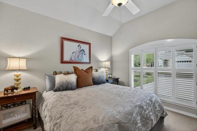 a bedroom with a large bed and a window