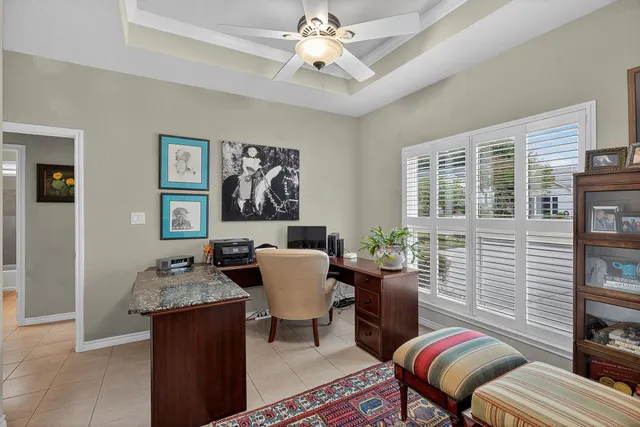 a dining room with furniture a rug and a chandelier