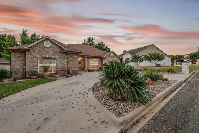 a view of a porch with a table chairs and floor to ceiling window