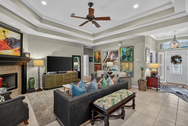 a living room with furniture a flat screen tv and a fireplace
