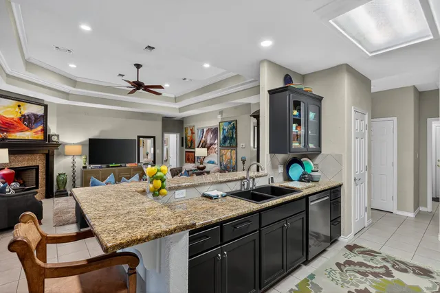 a kitchen with sink and view of living room