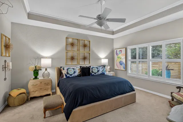 a bedroom with a bed couch and window