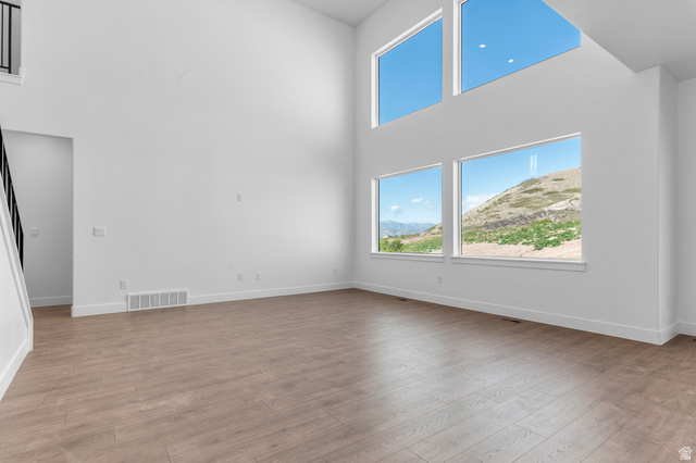 1341 West 2350 South, Unit 10 Perry, UT 84302 - Photo 4 of 18 Expansive interior space featuring a two-story ceiling and wood-finish flooring