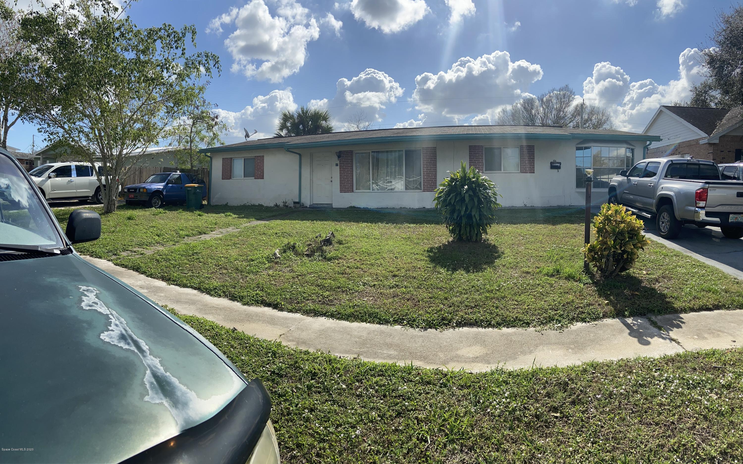 1717 Sarno Road Melbourne, FL 32935 - Photo 1 of 1 a view of a house with a yard and a garden