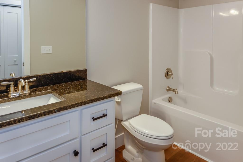 136 Augusta Drive Spindale, NC 28160 - Photo 11 of 19 a bathroom with a granite countertop toilet sink and mirror